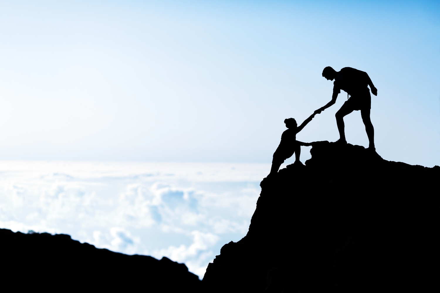 Couple hiking teamwork partners help each other silhouette in mountains, motivation and inspiration. Man and woman hiker helping hand trust on top of mountain climbing, beautiful sunset landscape.