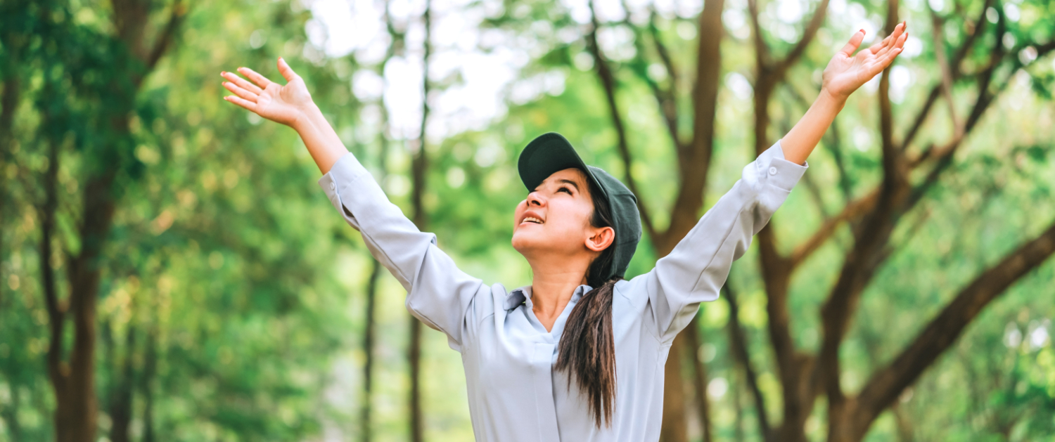 Asian women raise their hands to nature in the forest .people protect from deforestation and pollution or climate change Concept to love nature and tree . environment ecology and Earth Day concept